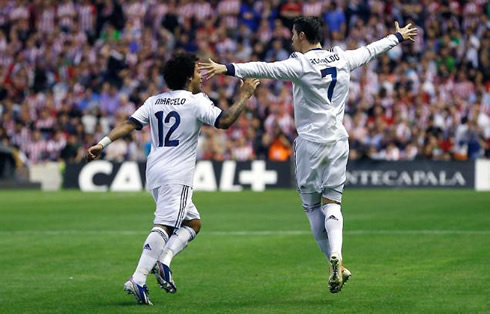 Cristiano Ronaldo running with his arms stetched, as Marcelo tries to catch him, in Athletic Bilbao 0-3 Real Madrid, for La Liga 2013