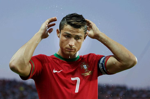 Cristiano Ronaldo fixing his hair with water, during a game for Portugal
