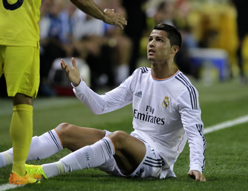 Cristiano Ronaldo asks his opponent for explanations while he is sitted on the ground