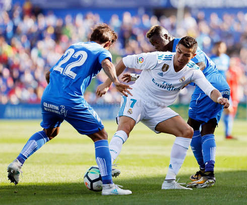 Cristiano Ronaldo trying to proctect the ball from two opponents