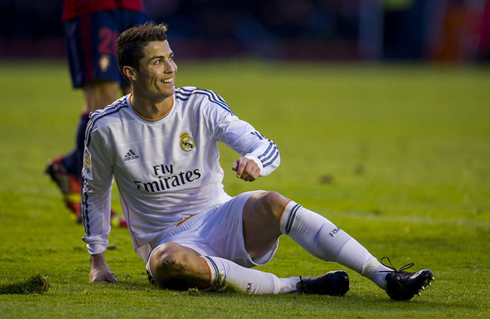 Cristiano Ronaldo slowly getting up from the ground as he unveils a sarcastic smile