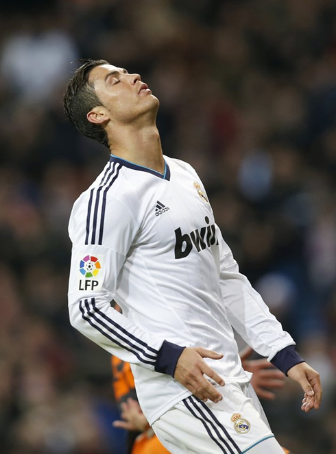 Cristiano Ronaldo leaning his head back and closing his eyes, during a game for Real Madrid in 2013
