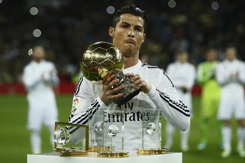 Cristiano Ronaldo taking a photo with the 2014 FIFA Ballon d'Or at the Santiago Bernabéu