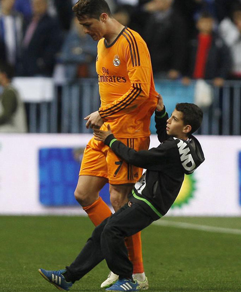 Cristiano Ronaldo getting his jersey pulled by a young fan