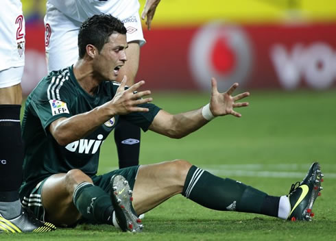 Cristiano Ronaldo complaining and yelling on the ground, after suffering a foul inside Sevilla's penalty-area that the referee didn't see