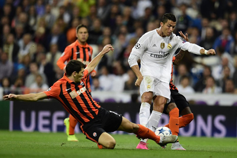 Cristiano Ronaldo gets tackled in an attacking play of Real Madrid vs Shakhtar Donetsk