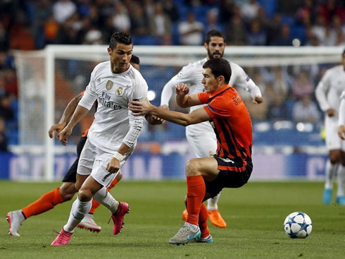 Cristiano Ronaldo tries to run away from a defender in a Champions League fixture between Real Madrid and Shakhtar
