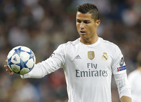 Cristiano Ronaldo grabs his hat-trick ball after a Real Madrid beats Shakhtar 4-0 at the Bernabéu