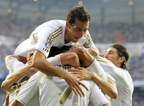 Cristiano Ronaldo hugging his Real Madrid teammates, with Arbeloa on the top