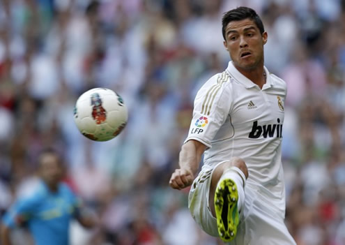 Cristiano Ronaldo stretching his right leg to reach the ball