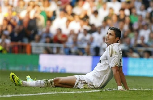 Cristiano Ronaldo exhausted layed on the ground with his legs open