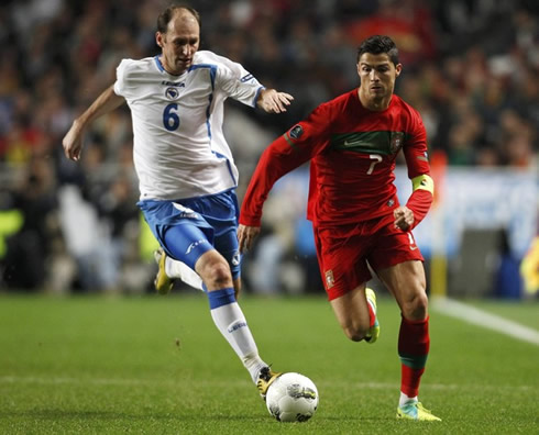 Cristiano Ronaldo being chased by a Bosnian defender