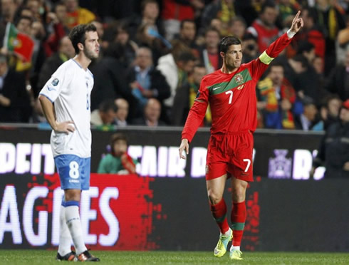 Cristiano Ronaldo pointing to the crowd, dedicating his goal, while Pjanic looks powerless