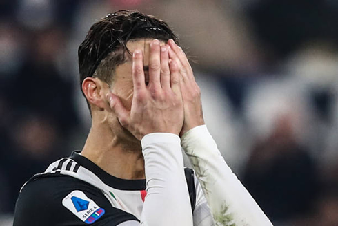 Cristiano Ronaldo covering his face with his hands