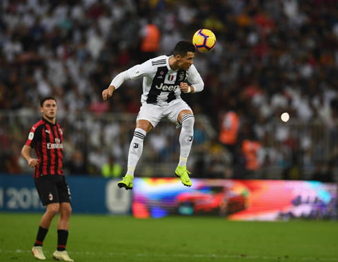 Cristiano Ronaldo jumps high in the air to head a ball