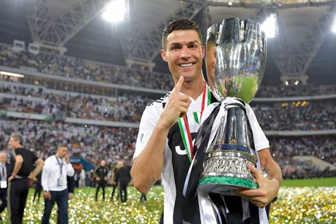 Cristiano Ronaldo holds the Italian Super Cup trophy, his first title with Juventus