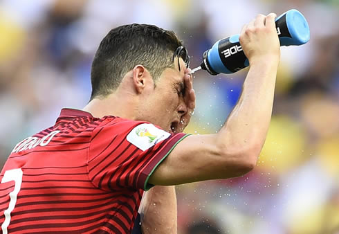 Cristiano Ronaldo spilling water on his face at the World Cup 2014