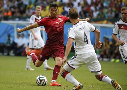 Cristiano Ronaldo striking the ball with Mats Hummels in front, in Germany 4-0 Portugal in the FIFA World Cup 2014