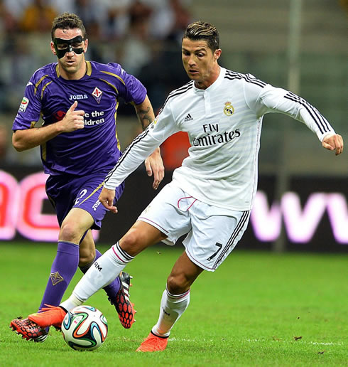 Cristiano Ronaldo being chased by a man wearing a mask