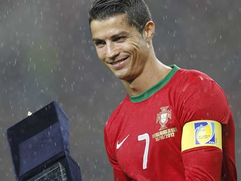 Cristiano Ronaldo smiling as he receives his 100th cap prize, before Portugal takes on Northern Ireland, in the Estádio do Dragão, in Porto, 2012