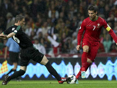 Cristiano Ronaldo trying to avoid a tackle from an Irish defender, in Portugal 1-1 Northern Ireland, for the 2014 WC qualifiers