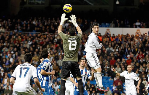Cristiano Ronaldo trying to head the ball past Francisco Casilla, in Real Madrid vs Espanyol for La Liga 2012-2013