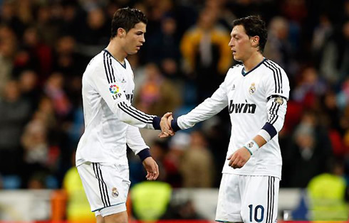 Cristiano Ronaldo giving hands to Mesut Ozil, in Real Madrid 2012-2013