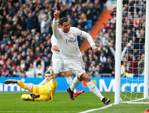 Cristiano Ronaldo raises his finger after scoring his first goal of the match against Sporting Gijón