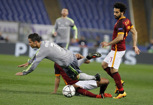 Cristiano Ronaldo getting tackled by a Roma defender, in Real Madrid away trip to Italy