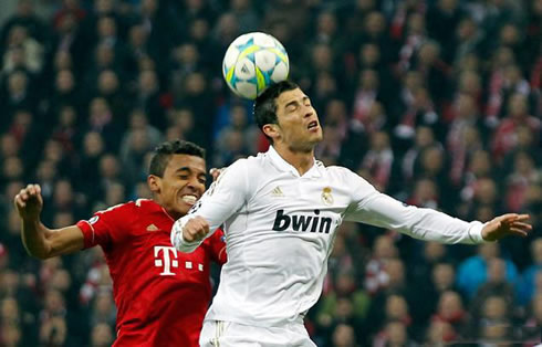 Cristiano Ronaldo raising higher than a Bayern Munich defender and heading the ball