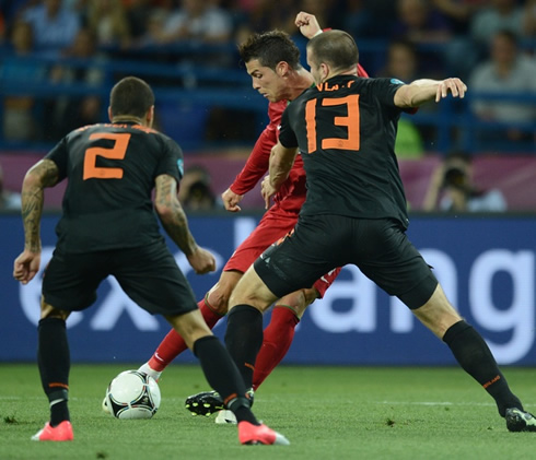 Cristiano Ronaldo trying to find room to shoot, in Portugal vs Holland during the EURO 2012, as Ron Vlaar attempts to block it