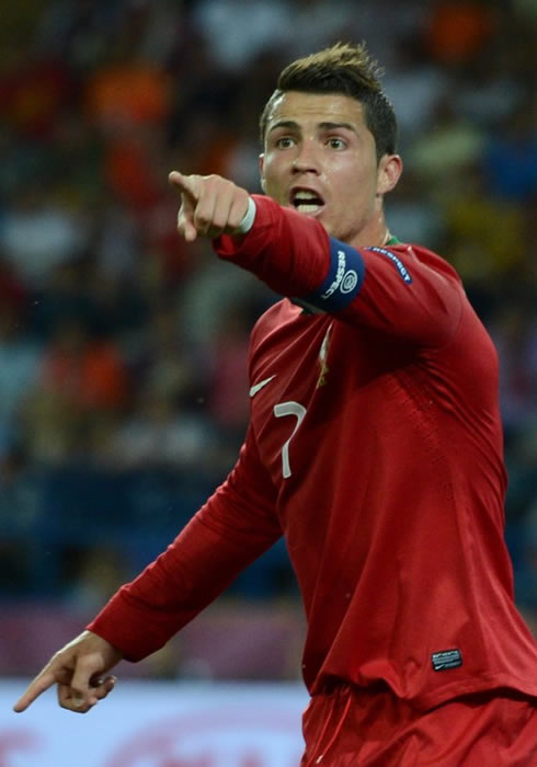 Cristiano Ronaldo in panic pointing at something ahead of him, in the EURO 2012