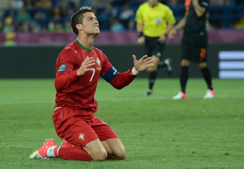 Cristiano Ronaldo gets on his knees and prays, at the EURO 2012
