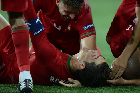 Cristiano Ronaldo lied down on the pitch as Portuguese players pile up on top of him, in the EURO 2012