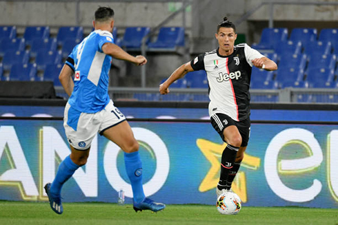 Cristiano Ronaldo taking on a defender in Napoli vs Juventus