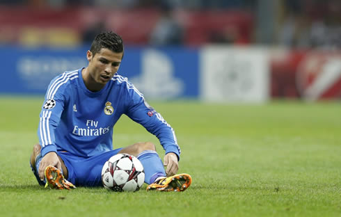 Cristiano Ronaldo looking to be down as he sits over and stares the ball