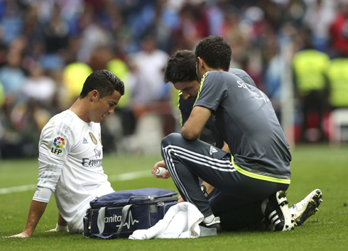 Cristiano Ronaldo being assisted by Real Madrid doctors after picking up a small injury