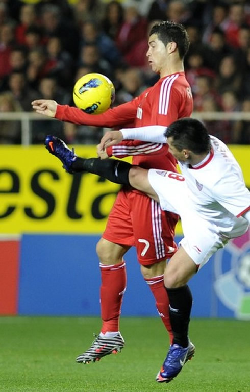 Cristiano Ronaldo protecting the ball from a Sevilla defender