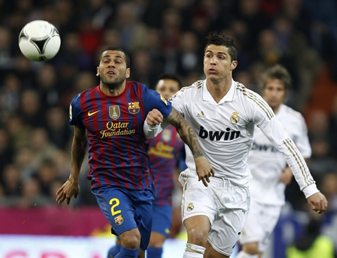 Cristiano Ronaldo tries to get ahead of Barcelona's Daniel Alves, when chasing the ball