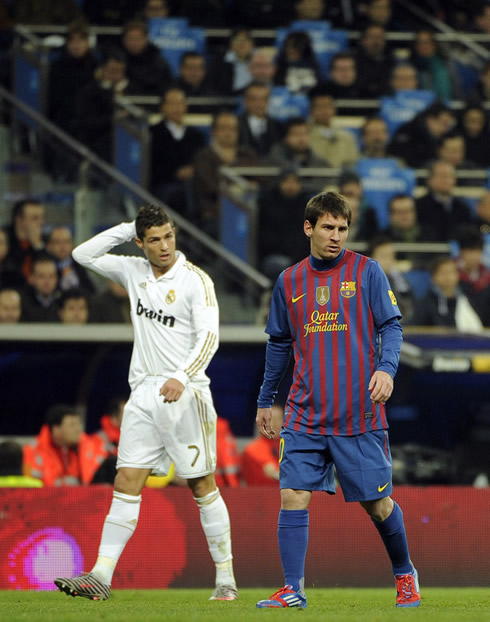 Cristiano Ronaldo with his right hand on his head, while looking at Lionel Messi, in the Clasico Real Madrid vs Barcelona, in the Copa del Rey 2012