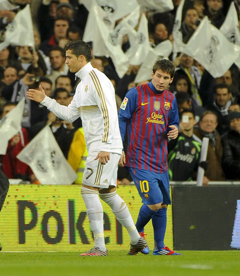Cristiano Ronaldo saluting Barcelona players, while Lionel Messi gets around him, in a Real Madrid vs Barcelona game, in 2012