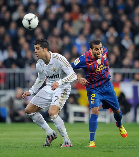 
Cristiano Ronaldo heads the ball before Daniel Alves, as the two players collide in Real Madrid 1-2 Barcelona, for the Copa del Rey 2012