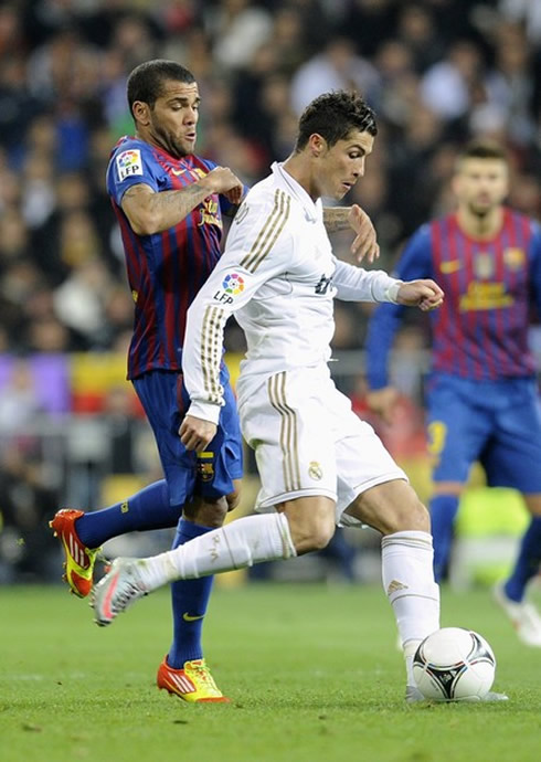 Cristiano Ronaldo being pushed by Daniel Alves, in the Clasico Real Madrid vs Barcelona, 2011-2012