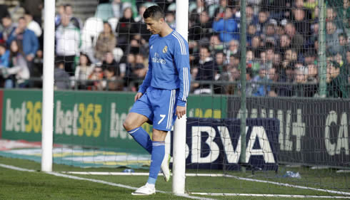 Cristiano Ronaldo puts his back against the post and looks down