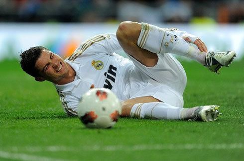Cristiano Ronaldo lied on the pitch, holding his left ankle in pain
