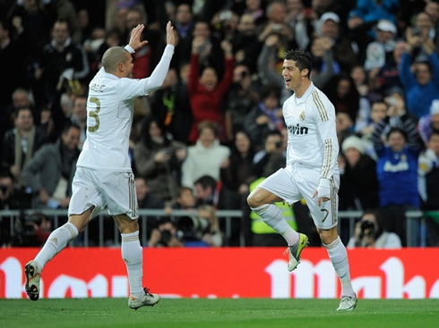 Cristiano Ronaldo marching towards Pepe, as they celebrate Real Madrid first goal against Racing Santander, in 2012