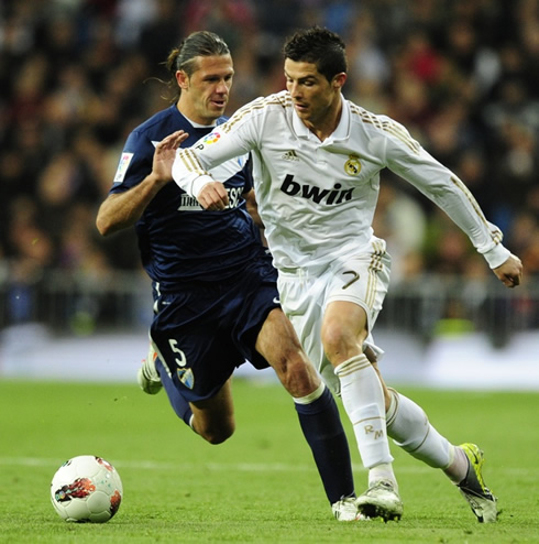 Cristiano Ronaldo running in front of Martin DeMichelis in Real Madrid 1-1 Malaga