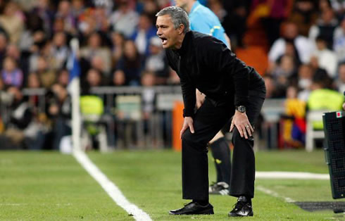 José Mourinho wearing a black uniform and sending instructions to Real Madrid players during a La Liga game in 2012