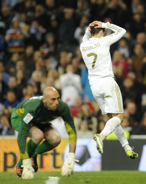 Cristiano Ronaldo puts his hands on the back of his head, after a miss against Malaga