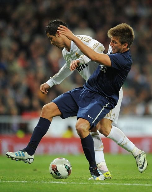 Cristiano Ronaldo pushing a Malaga defender in a Real Madrid game